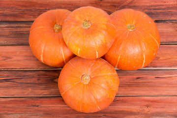 Orange pumpkins on a wooden table