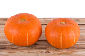 Orange pumpkins on a wooden table