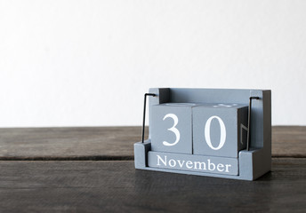 November 30th. Day 30 of month, modern calenda on wood table.
