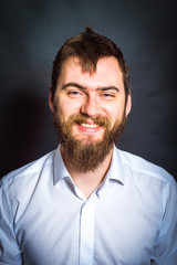 man smiling on a black background