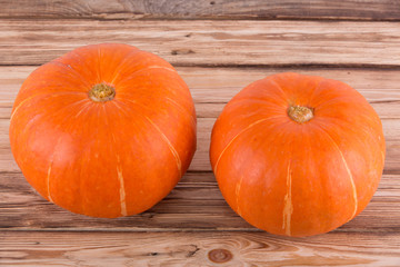 Orange pumpkins on a wooden table