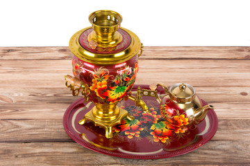Traditional Russian samovar and a teapot on a tray on white background