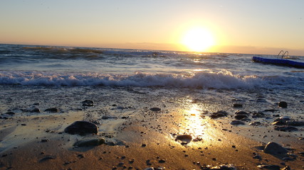 The sun rises over the waves