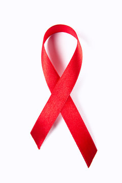 Red ribbon as symbol of aids awareness isolated on white