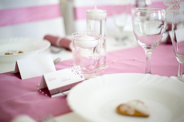 Pink and white wedding table with small round white tea candle i