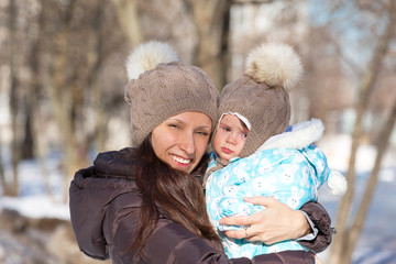 Fototapeta premium Mother and child on a winter walk