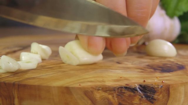 Cutting garlic on a wooden cutting board