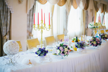Festive table decorated with flowers and candles