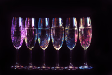 Fireworks reflected in the glasses of champagne. New Year's decoration.