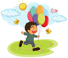 Little boy holding balloons in the park