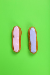 Eclairs with glaze on a paper background