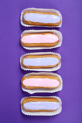 Eclairs with glaze on a paper background