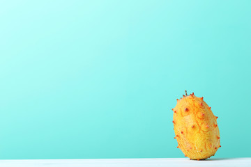 Kiwano fruit on white wooden table