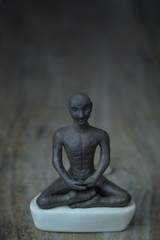 Silhouette young monk statue praying practicing yoga and meditate. Vipassana concept. Yoga, health life concept.