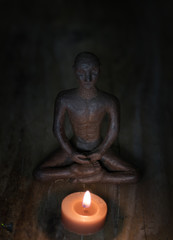 Fototapeta na wymiar Silhouette young monk statue praying practicing yoga and meditate. Vipassana concept. Yoga, health life concept.