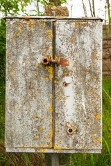 rusty aged metallic box on column