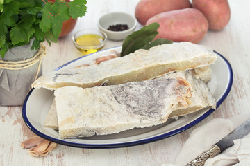 cod fish with potato on wooden background