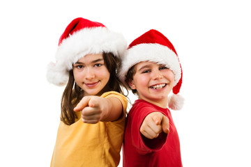 Christmas time - girl and boy with Santa Claus Hat pointing