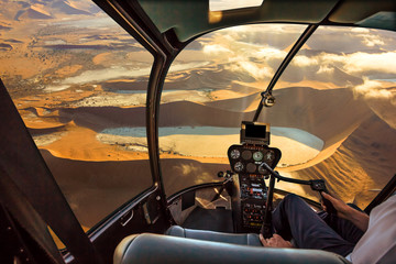 Helicopter cockpit flies in Deadvlei, Sossusvlei desert in Namib Naukluft National Park, Namibia,...