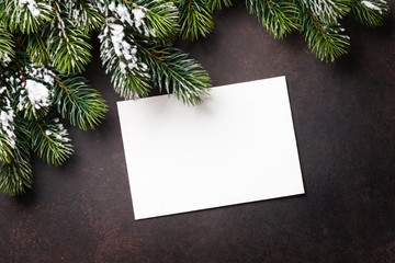 Fototapeta na wymiar Christmas greeting card and fir tree over stone background