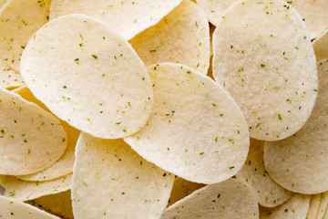 Close up potato chips on wood top view background.