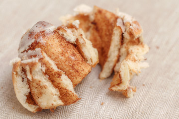 Freshly cinnabon French bun with cinnamon and cream, selective focus