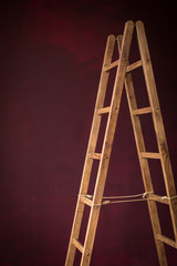 wooden staircase on burgundy background