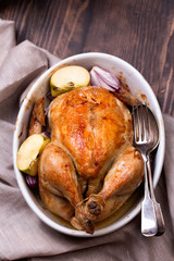 roasted chicken on wooden table, top view