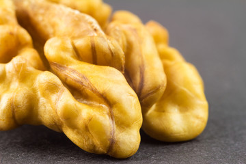 Kernel walnut on black background macro image.