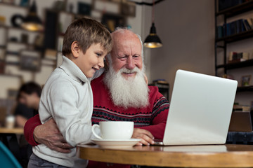 Grandfather and grandson near laptop