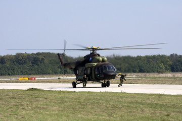 Fototapeta na wymiar Soldiers boarding helicopter