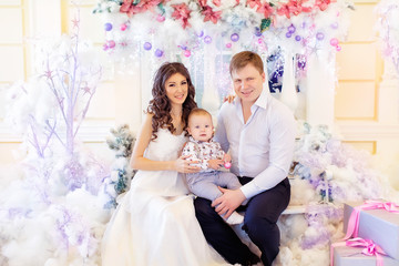 Happy family with child son lying near Christmas tree