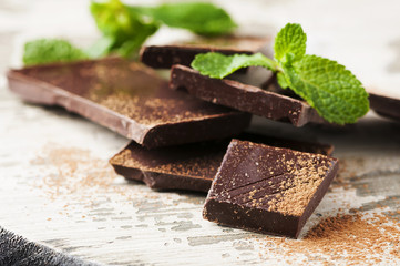 Brown chocolate and mint on the wooden table