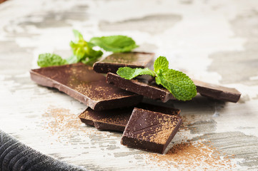 Brown chocolate and mint on the wooden table