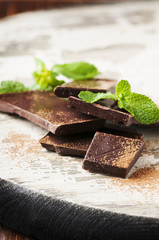 Brown chocolate and mint on the wooden table