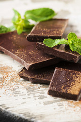 Brown chocolate and mint on the wooden table