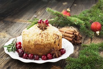 Fragrant homemade muffins with cranberries, candied fruits soaked in brandy, herbs and spices on a wooden dark background. Served  rosemary. selective focus