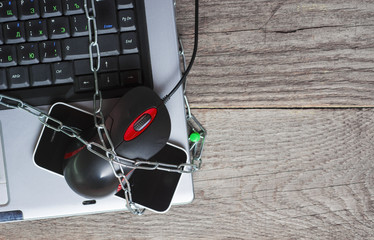 laptop and other devices wrapped by chain - Computer Security Day 