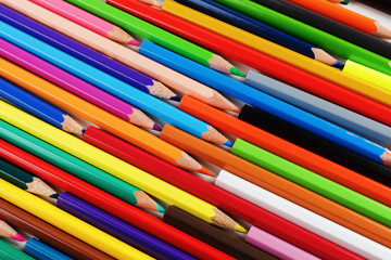Bright color pencils lying on a flat surface. Colored pencils as background.