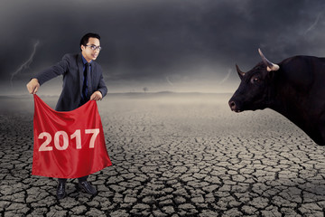 Businessman fighting with bull