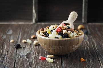 Mix of dried nuts and fruits on the wooden table