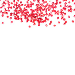 White background with red pomegranate (garnet) seeds