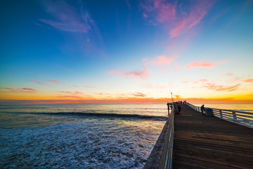 Wooden pier in Pacific Beach at sunset - obrazy, fototapety, plakaty