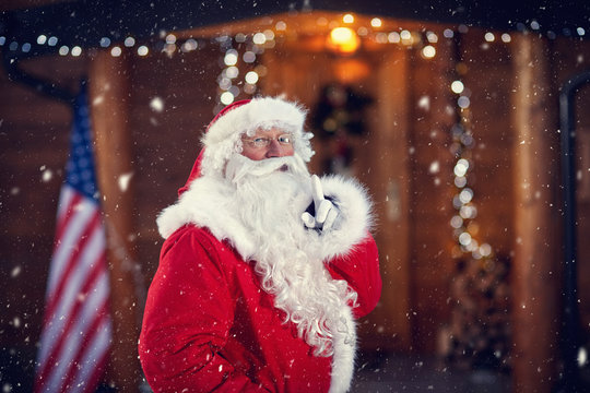 Santa Claus holding finger on mouth