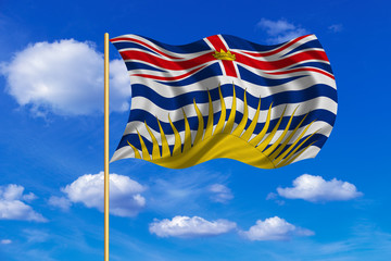 Flag of British Columbia on flagpole wavy blue sky