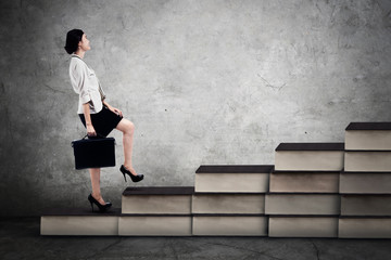 Female worker walks on the books stair
