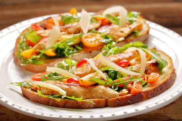 Chicken sandwich on fresh bread with arugula tomato and cheese