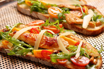 Chicken sandwich on fresh bread with arugula tomato and cheese