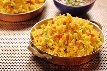 Chicken with basmati rice fried in stainless pan