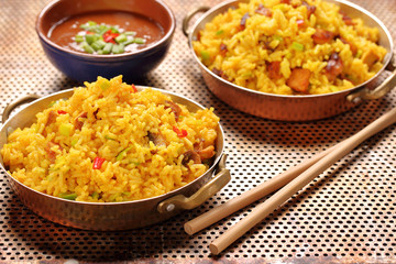 Chicken with basmati rice fried in stainless pan